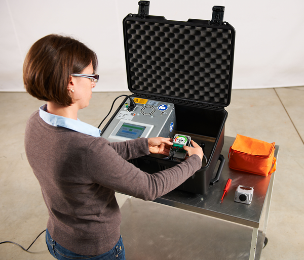 Woman using gas monitoring equipment