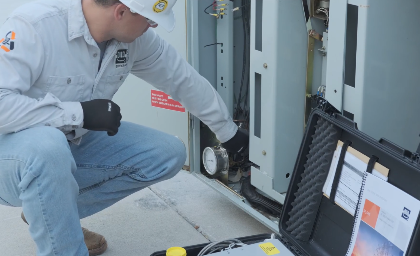 a man checking pressure on GIE 2 as part of sf6 gas hazard procedures