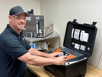 DILO technician performing SF6 Analyzer Calibration